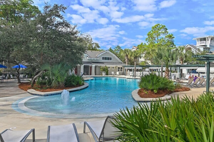Freeform Community Pool with Fountain and Tropical Landscaping