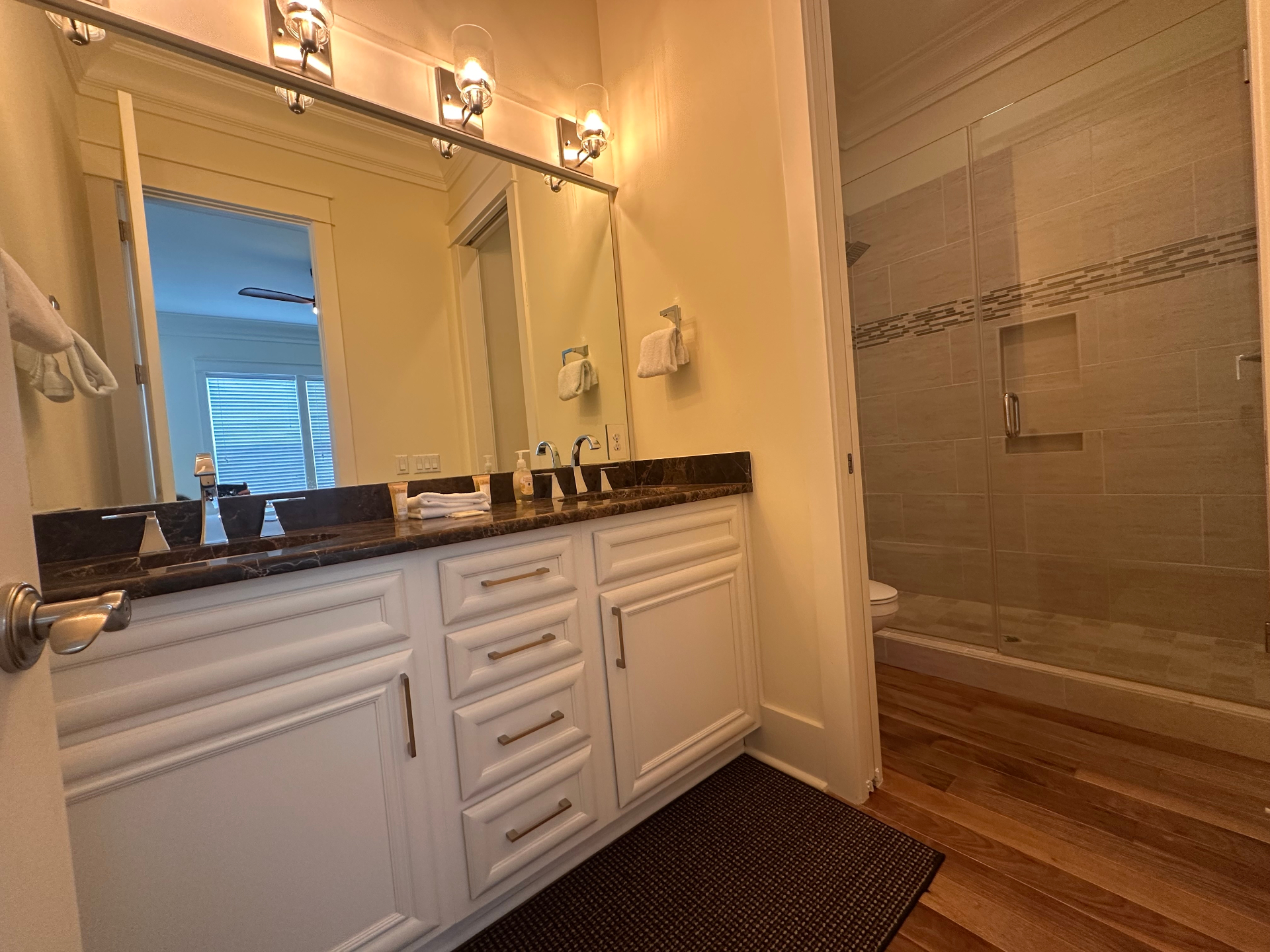 Guest Bathroom with Oversized Mirror and Glass Shower